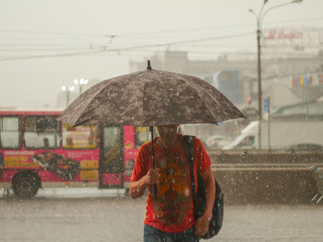 man standing under umbrella